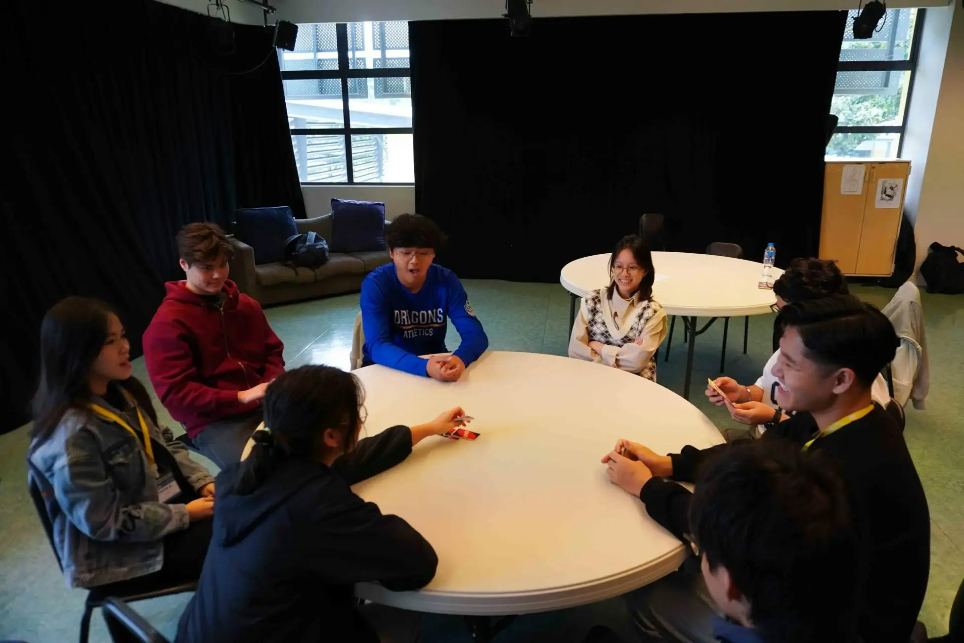 MLV students sitting in a round table playing UNO together